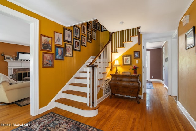 1435 Lowell Rd, Schenectady, NY 12308 - stairway with wood finished floors, baseboards, and crown molding