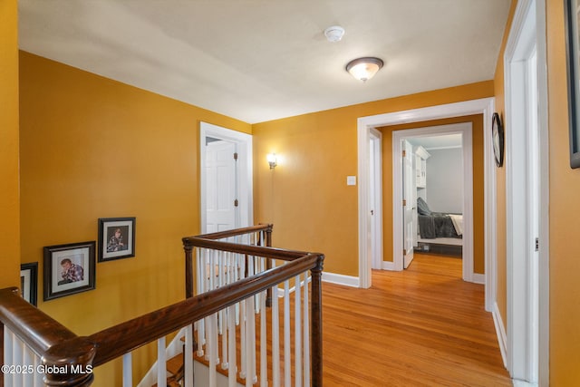 1435 Lowell Rd, Schenectady, NY 12308 - hallway with an upstairs landing, light wood-style flooring, and baseboards