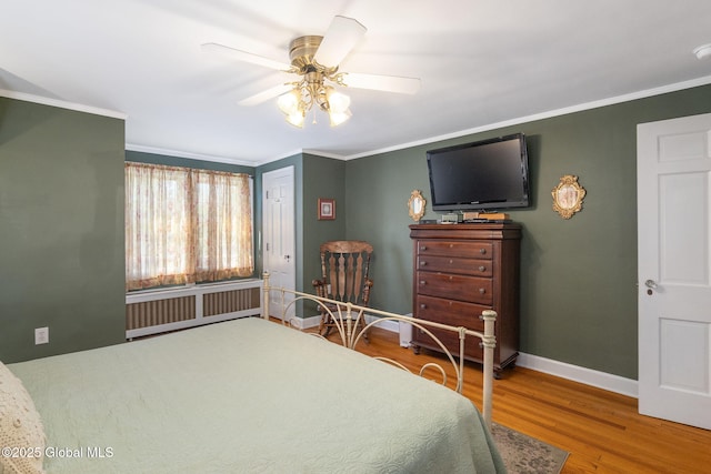 1435 Lowell Rd, Schenectady, NY 12308 - bedroom featuring radiator, wood finished floors, crown molding, baseboards, and ceiling fan