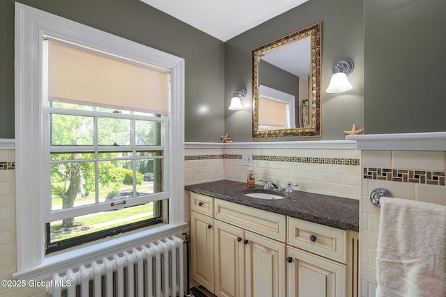 1435 Lowell Rd, Schenectady, NY 12308 - bathroom featuring radiator, healthy amount of natural light, vanity, and tile walls