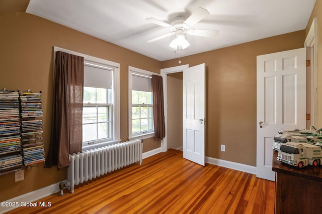 1435 Lowell Rd, Schenectady, NY 12308 - bedroom with radiator, light wood-style flooring, baseboards, and ceiling fan