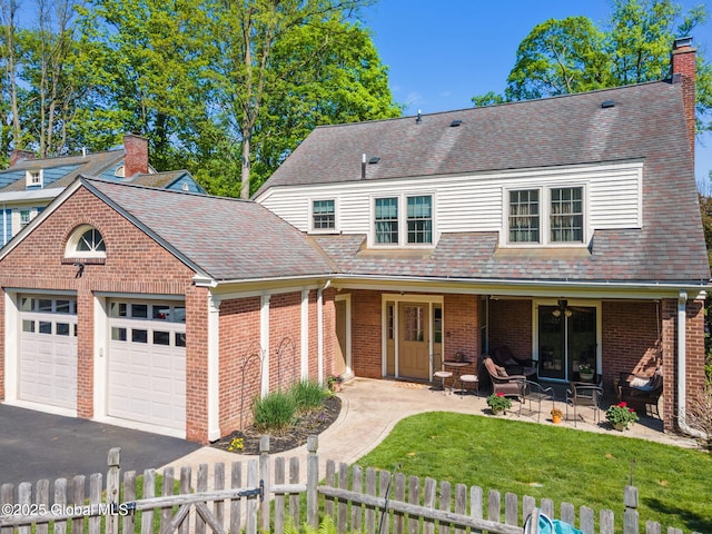1435 Lowell Rd, Schenectady, NY 12308 - traditional home with a garage, brick siding, driveway, a chimney, and a shingled roof
