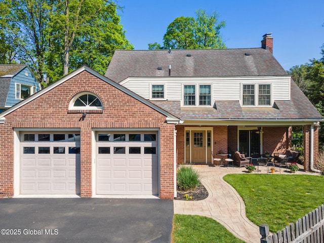 1435 Lowell Rd, Schenectady, NY 12308 - view of front of house featuring driveway, brick siding, a garage, a chimney, and a front yard