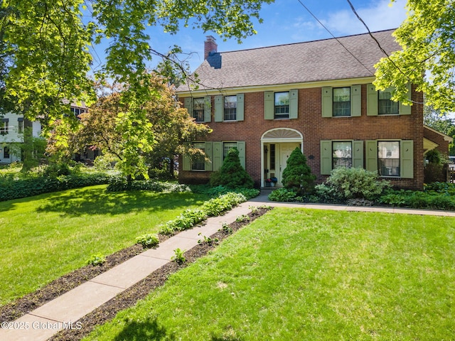 1435 Lowell Rd, Schenectady, NY 12308 - view of front of property featuring brick siding, a chimney, and a front yard
