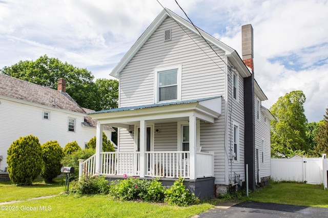 127 John St, Hudson Falls, NY 12839 - view of front of home featuring a porch and a chimney