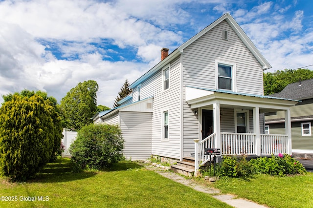 127 John St, Hudson Falls, NY 12839 - view of front of property featuring covered porch, a chimney, and a front yard