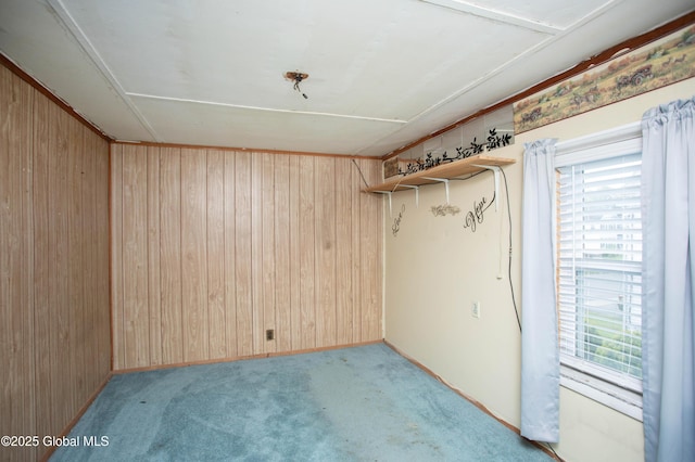 127 John St, Hudson Falls, NY 12839 - empty room with wood walls, healthy amount of natural light, and light colored carpet