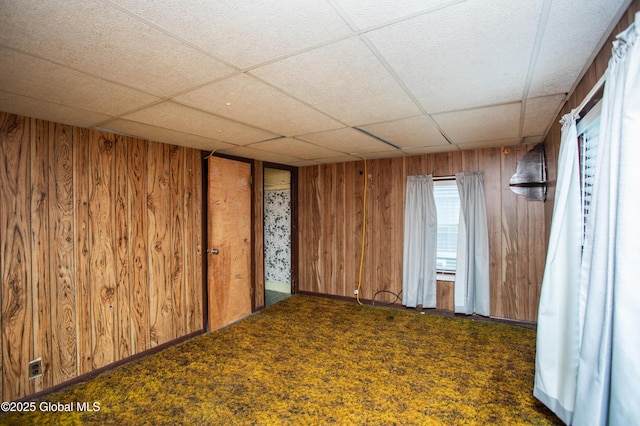 127 John St, Hudson Falls, NY 12839 - spare room with wooden walls, a paneled ceiling, and carpet
