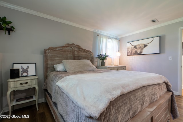 bedroom with wood finished floors, crown molding, and baseboards