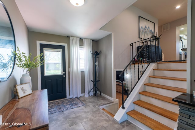 foyer with stairs and baseboards