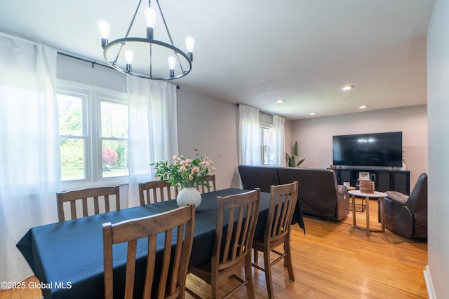 dining area featuring a chandelier, light wood finished floors, and recessed lighting
