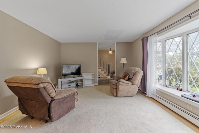 15 Oak Tree Ln, Colonie, NY 12309 - carpeted living room featuring baseboard heating, stairway, plenty of natural light, and baseboards