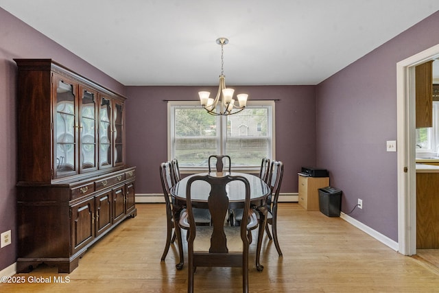 15 Oak Tree Ln, Colonie, NY 12309 - dining space featuring a chandelier, a baseboard radiator, light wood-type flooring, and baseboards