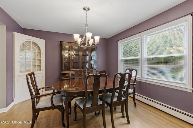 15 Oak Tree Ln, Colonie, NY 12309 - dining area featuring a chandelier, light wood-style floors, baseboards, and a baseboard heating unit