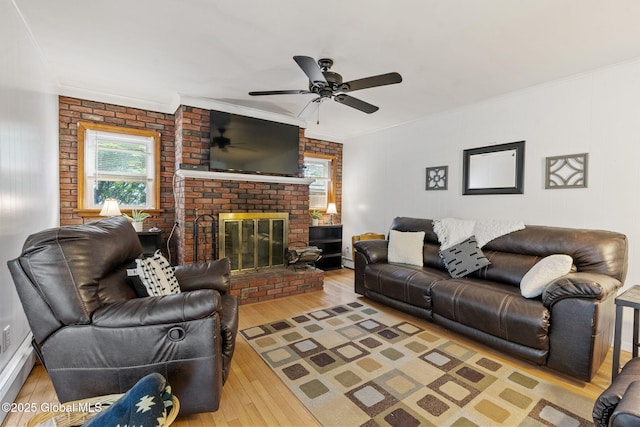 15 Oak Tree Ln, Colonie, NY 12309 - living area with wood finished floors, crown molding, a ceiling fan, a brick fireplace, and brick wall