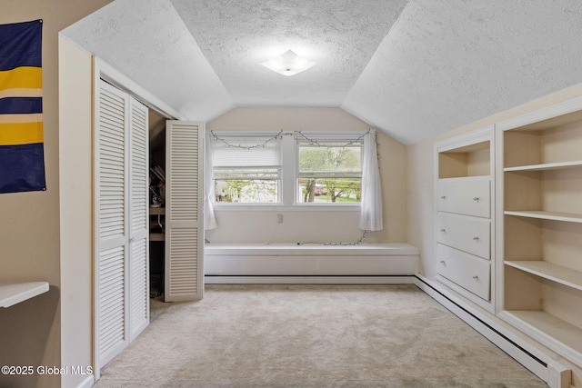 15 Oak Tree Ln, Colonie, NY 12309 - unfurnished bedroom featuring carpet, a closet, a textured ceiling, vaulted ceiling, and baseboard heating
