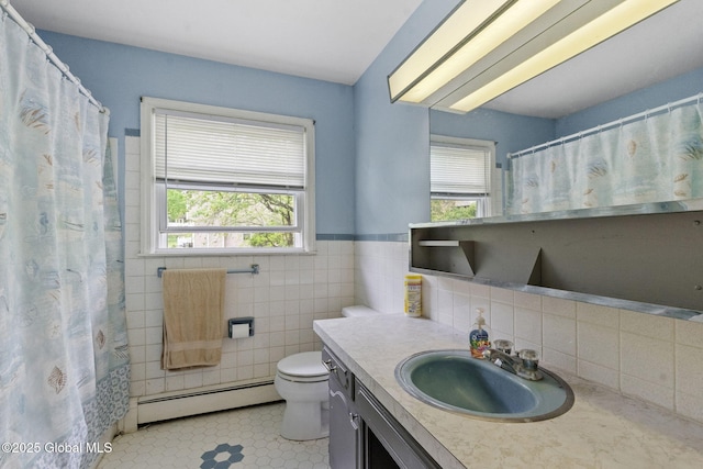 15 Oak Tree Ln, Colonie, NY 12309 - bathroom featuring a baseboard radiator, plenty of natural light, tile patterned flooring, toilet, and a wainscoted wall
