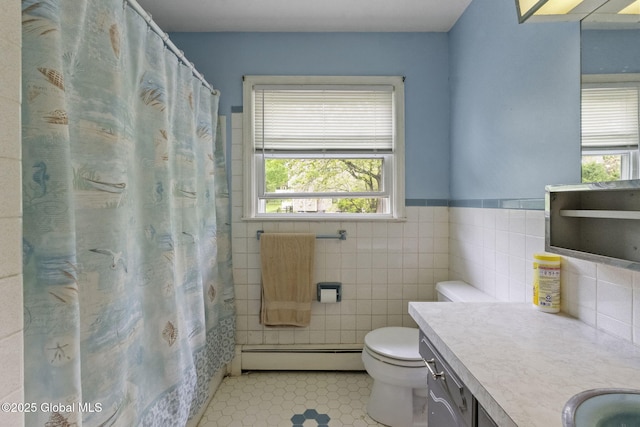 15 Oak Tree Ln, Colonie, NY 12309 - full bath with a baseboard heating unit, plenty of natural light, vanity, toilet, and tile walls