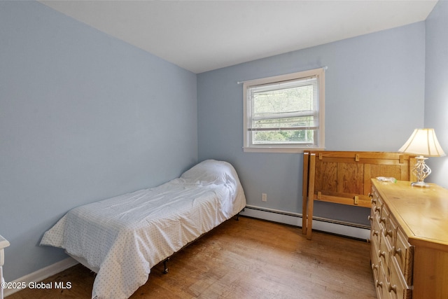 15 Oak Tree Ln, Colonie, NY 12309 - bedroom featuring a baseboard heating unit, light wood-style flooring, and baseboards