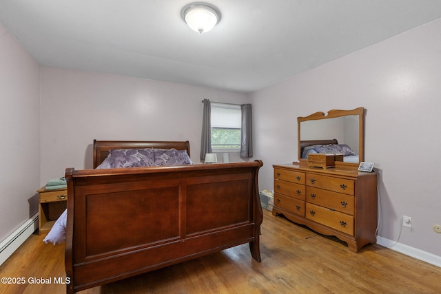 15 Oak Tree Ln, Colonie, NY 12309 - bedroom with light wood finished floors, a baseboard heating unit, and baseboards