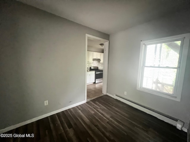 31-33 Malta Ave, Ballston Spa, NY 12020 - unfurnished room featuring baseboard heating, dark wood-style floors, and baseboards