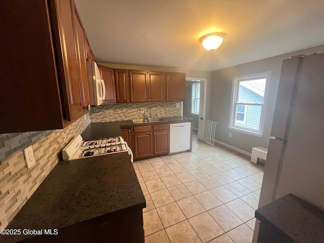 31-33 Malta Ave, Ballston Spa, NY 12020 - kitchen with white appliances, tasteful backsplash, a sink, light tile patterned flooring, and dark countertops