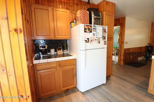11 Filkins Ln, Voorheesville, NY 12186 - kitchen featuring freestanding refrigerator, tile countertops, decorative backsplash, and light wood-style flooring