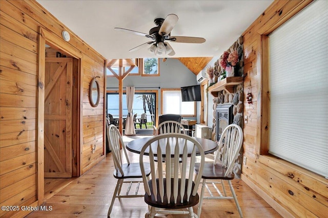 126 Lakeview Ln, Mayfield, NY 12117 - dining room with wooden walls, light wood finished floors, ceiling fan, and vaulted ceiling