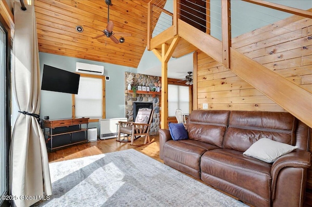 126 Lakeview Ln, Mayfield, NY 12117 - living area featuring ceiling fan, a wall unit AC, wood finished floors, lofted ceiling, and a stone fireplace