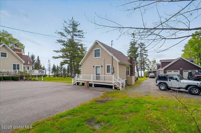 126 Lakeview Ln, Mayfield, NY 12117 - view of front facade featuring a chimney and a wooden deck