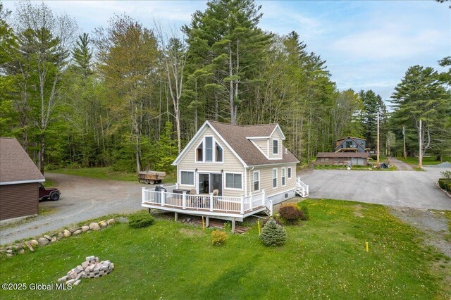 126 Lakeview Ln, Mayfield, NY 12117 - back of house featuring driveway, a forest view, and a lawn