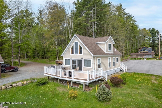 126 Lakeview Ln, Mayfield, NY 12117 - view of front facade featuring driveway, a forest view, a shingled roof, and a deck