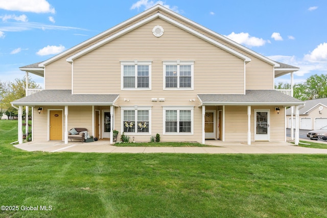back of property with a patio and a yard