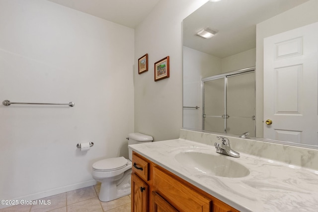 bathroom featuring a shower with shower door, tile patterned floors, toilet, vanity, and baseboards