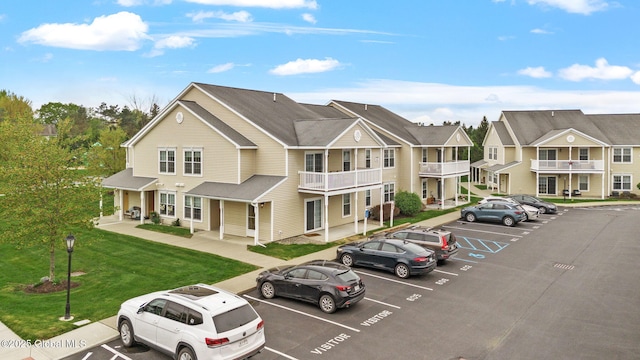 view of property featuring uncovered parking and a residential view