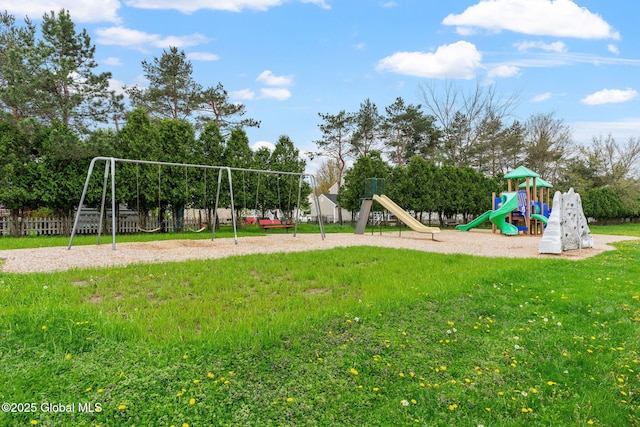 community play area with a yard and view of wooded area