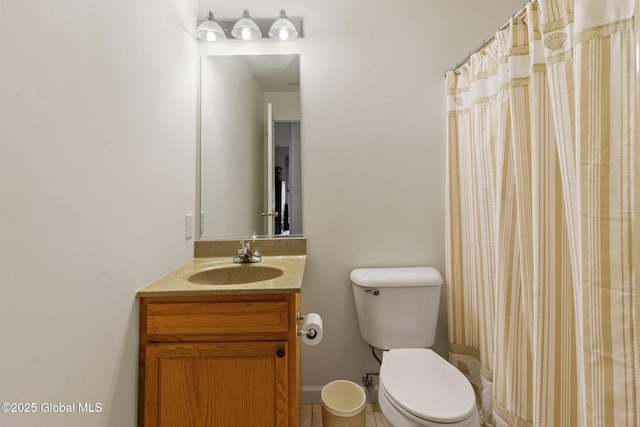 bathroom with toilet, vanity, tile patterned flooring, and curtained shower