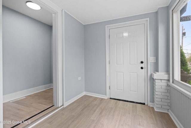 foyer featuring light wood finished floors and baseboards
