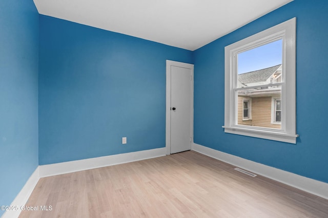 unfurnished room with wood finished floors and baseboards