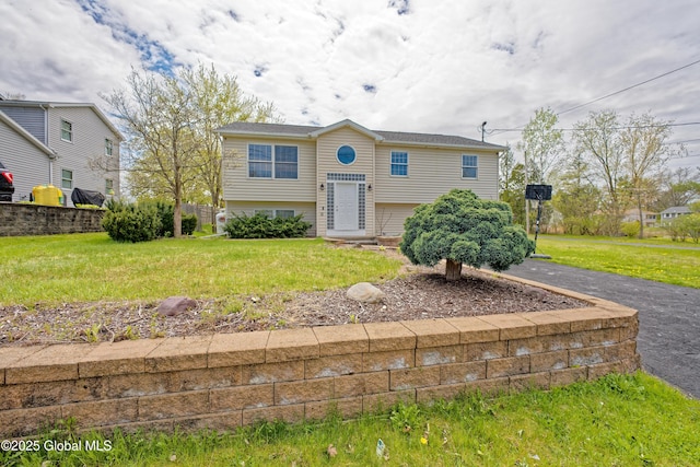 raised ranch with a front yard