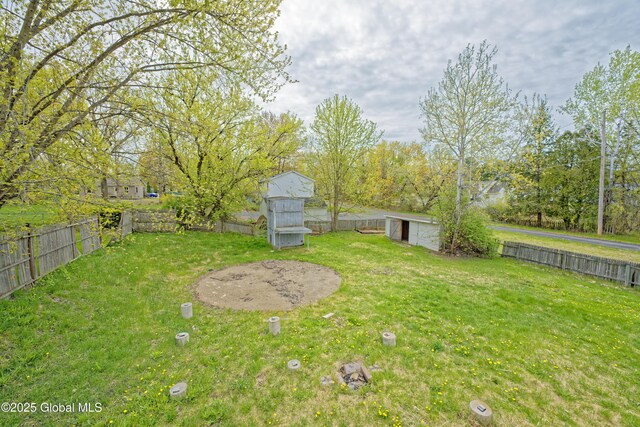 view of yard with a storage unit and an outbuilding