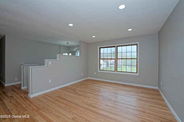 unfurnished room featuring light wood-style flooring, recessed lighting, and baseboards