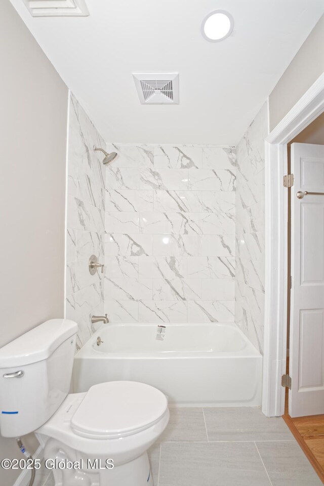 bathroom with toilet and tub / shower combination