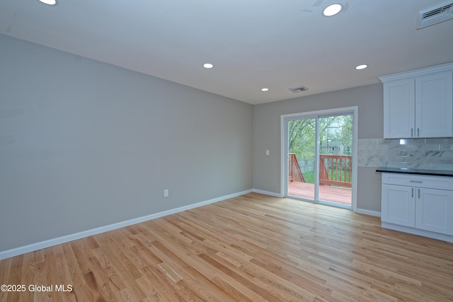 unfurnished living room with light wood-style flooring, baseboards, and recessed lighting