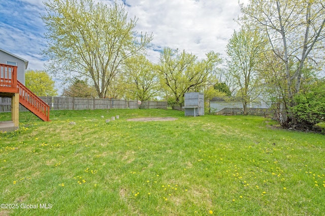 view of yard with stairs and a wooden deck