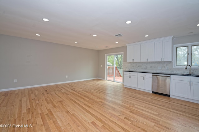 kitchen with dishwasher, recessed lighting, decorative backsplash, dark countertops, and light wood-style flooring