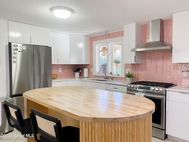 5 Moon Dr, Saratoga Springs, Inside, NY 12866 - kitchen featuring wall chimney exhaust hood, appliances with stainless steel finishes, a sink, butcher block counters, and a kitchen bar