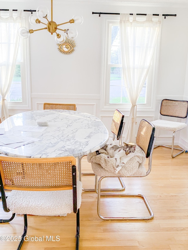 5 Moon Dr, Saratoga Springs, Inside, NY 12866 - dining room featuring plenty of natural light, wood finished floors, a decorative wall, a chandelier, and a wainscoted wall