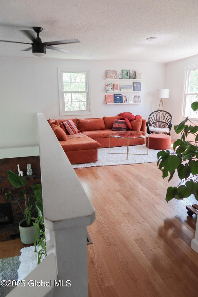 5 Moon Dr, Saratoga Springs, Inside, NY 12866 - living room featuring ceiling fan, wood finished floors, a textured ceiling, and a fireplace