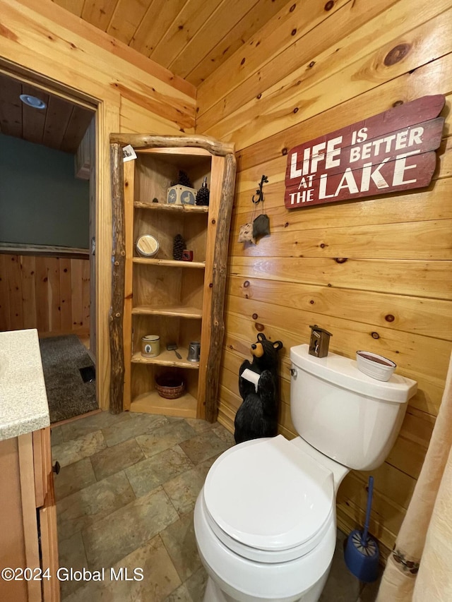 166 Finkle Rd, Bolton, NY 12814 - bathroom featuring wood walls, wooden ceiling, toilet, and stone finish flooring